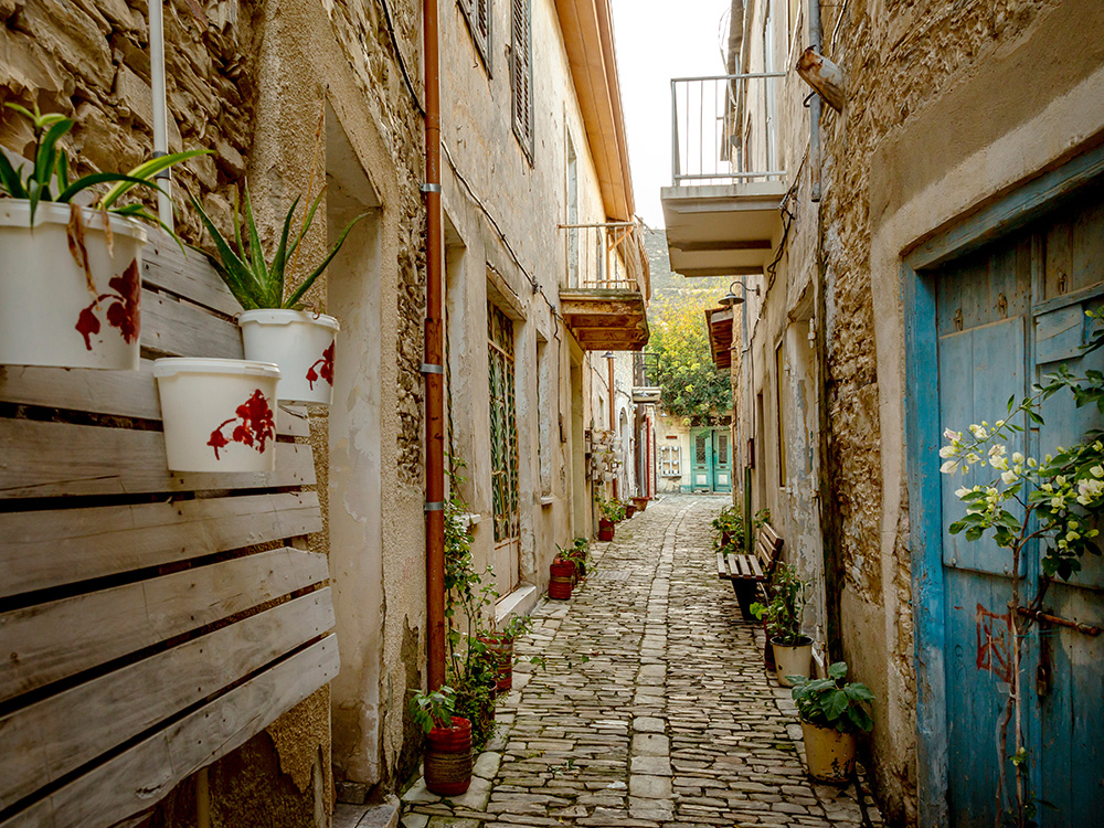 Narrow alley with doorways to homes in Lefkara village on Cyprus island.