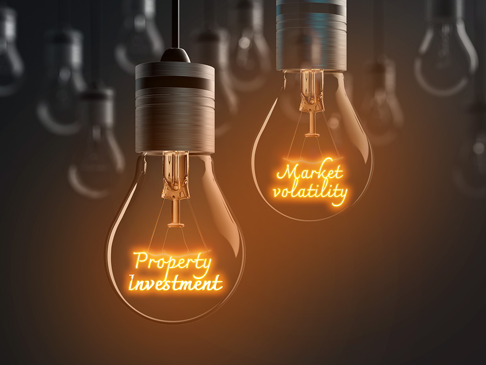 Lightbulbs showing the words Property investment and Market volatility