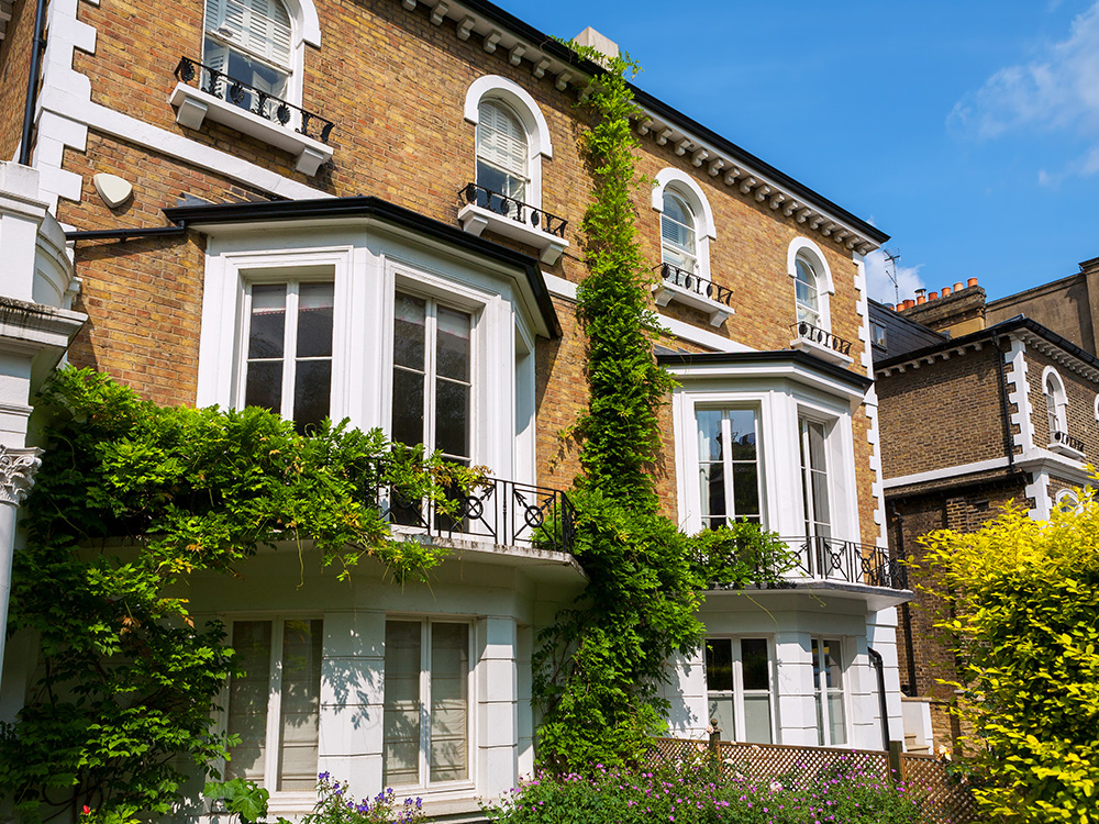 A large victorian London house with white bay windows